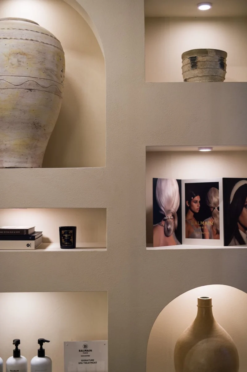 Arched shelves of products and ceramics inside the Studio Beige atelier
